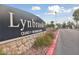 Entrance signage to the Lynbrook community featuring stonework and established landscaping at 5823 Falling Stream Ave, Las Vegas, NV 89131
