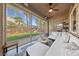 Cozy sunroom with a large window view to the backyard, comfortable seating, and a ceiling fan at 5823 Falling Stream Ave, Las Vegas, NV 89131