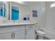 Bathroom with white cabinets, framed mirror, and a tub with white tile surround at 6131 Rio Vista St, Las Vegas, NV 89130