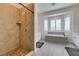 Elegant bathroom featuring a tile shower, soaking tub beneath a bay window and stylish fixtures at 6131 Rio Vista St, Las Vegas, NV 89130
