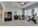 Bright exercise room with white window shutters, tray ceilings, and modern furniture at 6131 Rio Vista St, Las Vegas, NV 89130