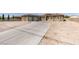 Spacious desert home featuring a long driveway and three-car garage, perfect for car enthusiasts at 6131 Rio Vista St, Las Vegas, NV 89130
