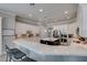 Kitchen features bar seating at the large island, stainless appliances, white cabinets, and mosaic backsplash at 6131 Rio Vista St, Las Vegas, NV 89130