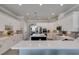Bright kitchen boasts white cabinetry, quartz countertops, mosaic backsplash, and a black island with pendant lighting at 6131 Rio Vista St, Las Vegas, NV 89130