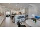 Open kitchen with white cabinets, breakfast bar, marble countertops, and stainless steel appliances at 6131 Rio Vista St, Las Vegas, NV 89130