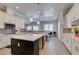 Spacious kitchen offers a black island, stainless steel appliances, mosaic backsplash, and wine rack storage at 6131 Rio Vista St, Las Vegas, NV 89130