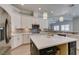 This bright kitchen features stainless steel appliances, white cabinets, quartz countertops, and bar seating at 6131 Rio Vista St, Las Vegas, NV 89130