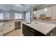 This kitchen features a large black island, quartz countertops, stainless steel appliances, and backsplash at 6131 Rio Vista St, Las Vegas, NV 89130