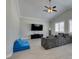 Large living room features vaulted ceilings, tile floors, media center, and a ceiling fan at 6131 Rio Vista St, Las Vegas, NV 89130