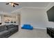 Bright living space features open-concept kitchen and modern sectional seating with television at 6131 Rio Vista St, Las Vegas, NV 89130