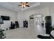 Open-concept living room featuring tile floors, modern furniture, a ceiling fan and ample natural light at 6131 Rio Vista St, Las Vegas, NV 89130