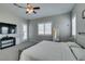 Bright main bedroom with white bedding, plush carpet, ceiling fan and a door to the outside at 6131 Rio Vista St, Las Vegas, NV 89130
