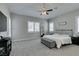 Spacious main bedroom features a comfortable bed, neutral carpet and stylish furnishings at 6131 Rio Vista St, Las Vegas, NV 89130