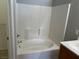 Full bathroom with white tub, tile surround, and chrome fixtures at 6170 E Sahara Ave # 1012, Las Vegas, NV 89142