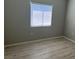 Neutral bedroom featuring wood-look laminate floors and a bright window at 6170 E Sahara Ave # 1012, Las Vegas, NV 89142
