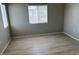 Neutral bedroom featuring wood-look laminate floors and a bright window at 6170 E Sahara Ave # 1012, Las Vegas, NV 89142