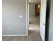 Hallway with wood-look laminate flooring leading to a kitchen at 6170 E Sahara Ave # 1012, Las Vegas, NV 89142