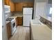 Well-maintained kitchen with white appliances, wood cabinets, and ample counter space for cooking at 6170 E Sahara Ave # 1012, Las Vegas, NV 89142