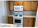 Clean kitchen featuring wooden cabinets, gas range, and ample counter space for meal preparation at 6170 E Sahara Ave # 1012, Las Vegas, NV 89142