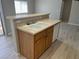 Kitchen featuring a sink, wooden cabinets, and a view into the dining area at 6170 E Sahara Ave # 1012, Las Vegas, NV 89142