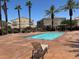 Community pool with lounge chair and desert landscaping at 6170 E Sahara Ave # 1012, Las Vegas, NV 89142