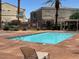 Enjoy this community pool surrounded by mature landscaping and lounge chairs at 6170 E Sahara Ave # 1012, Las Vegas, NV 89142