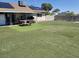 Residential backyard featuring artificial turf, covered patio, and concrete block perimeter wall at 6231 Santa Maria Ave, Las Vegas, NV 89108
