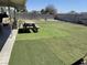 Large backyard featuring artificial turf sections, picnic table, and perimeter wall at 6231 Santa Maria Ave, Las Vegas, NV 89108