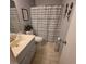 Standard bathroom featuring a toilet, sink with vanity, and a shower/tub combo with a striped curtain at 6231 Santa Maria Ave, Las Vegas, NV 89108