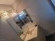 Traditional bathroom with a double-sink vanity and decorative light fixture at 6231 Santa Maria Ave, Las Vegas, NV 89108