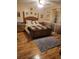 Comfortable bedroom with a wooden bed frame and matching wood flooring at 6231 Santa Maria Ave, Las Vegas, NV 89108