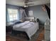 Comfortable bedroom features a large window with curtains and a ceiling fan at 6231 Santa Maria Ave, Las Vegas, NV 89108