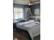 Cozy bedroom features a large window with curtains and a ceiling fan at 6231 Santa Maria Ave, Las Vegas, NV 89108