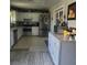 Traditional kitchen featuring white cabinets, stainless steel appliances, and neutral tile flooring at 6231 Santa Maria Ave, Las Vegas, NV 89108
