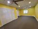 Bright living room featuring a large window, ceiling fan, and ample closet space at 6231 Santa Maria Ave, Las Vegas, NV 89108
