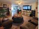 A cozy living room with couch, beanbag, mounted TV, and adjoining spaces, bathed in natural light at 6231 Santa Maria Ave, Las Vegas, NV 89108