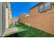 Small backyard with artificial grass and a concrete patio area at 6255 W Arby Ave # 258, Las Vegas, NV 89118
