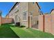 Small backyard with artificial grass, a block wall, and a metal gate at 6255 W Arby Ave # 258, Las Vegas, NV 89118