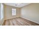 Bedroom features a ceiling fan, window, and neutral-colored walls with wood-look flooring at 6255 W Arby Ave # 258, Las Vegas, NV 89118