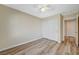 This bedroom features wood-style floors, a ceiling fan, and a closet with white sliding doors at 6255 W Arby Ave # 258, Las Vegas, NV 89118