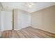 This bedroom features wood-style floors, a ceiling fan, and a closet with white sliding doors at 6255 W Arby Ave # 258, Las Vegas, NV 89118