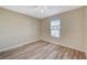 This bedroom features wood-style floors, a ceiling fan, and a window for natural light at 6255 W Arby Ave # 258, Las Vegas, NV 89118