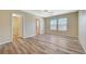 Bedroom featuring neutral walls, wood-look flooring, ceiling fan and windows for natural light at 6255 W Arby Ave # 258, Las Vegas, NV 89118