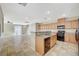 Inviting kitchen boasts tile floors, wood cabinets, black appliances, and a convenient breakfast bar at 6255 W Arby Ave # 258, Las Vegas, NV 89118
