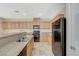 Well-appointed kitchen area featuring modern appliances, tile floors, and breakfast bar seating at 6255 W Arby Ave # 258, Las Vegas, NV 89118