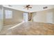 Spacious living room featuring neutral walls, tile flooring, ceiling fan, and sliding glass door at 6255 W Arby Ave # 258, Las Vegas, NV 89118