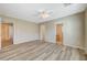 Spacious main bedroom boasts wood-look flooring, ceiling fan, and access to en-suite bathroom and walk-in closet at 6255 W Arby Ave # 258, Las Vegas, NV 89118