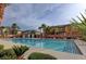 Community pool with a bath house and palm trees at 6255 W Arby Ave # 258, Las Vegas, NV 89118