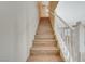 Staircase with wood steps and white railing leading to the upper level of the home at 6255 W Arby Ave # 258, Las Vegas, NV 89118
