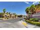 Beautifully landscaped community entrance featuring palm trees and well-maintained street view at 6255 W Arby Ave # 258, Las Vegas, NV 89118
